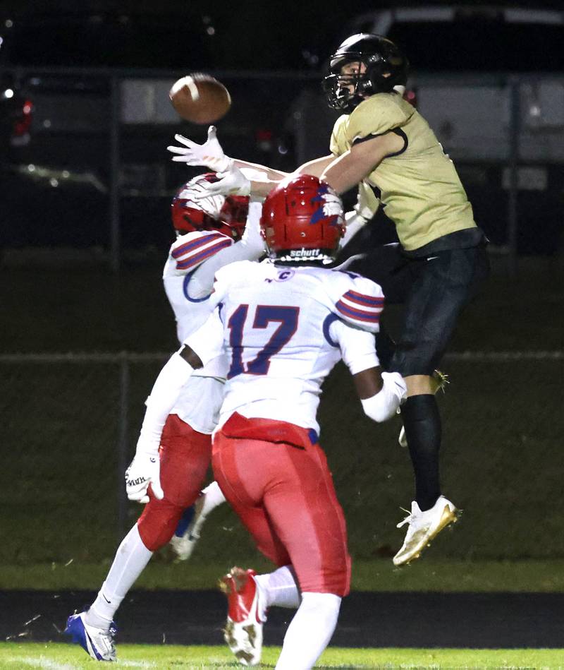 Sycamore's Aidan Wyzard goes up between a pair of Cahokia defenders to try and catch a pass during their game Friday, Oct. 25, 2024, at Sycamore High School.