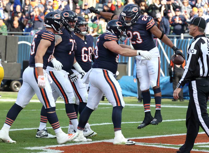 Chicago Bears running back Roschon Johnson (right) celebrates with teammates after scoring a touchdown Sunday, Nov. 17, 2024, during their game against the Green Bay Packers at Soldier Field in Chicago.