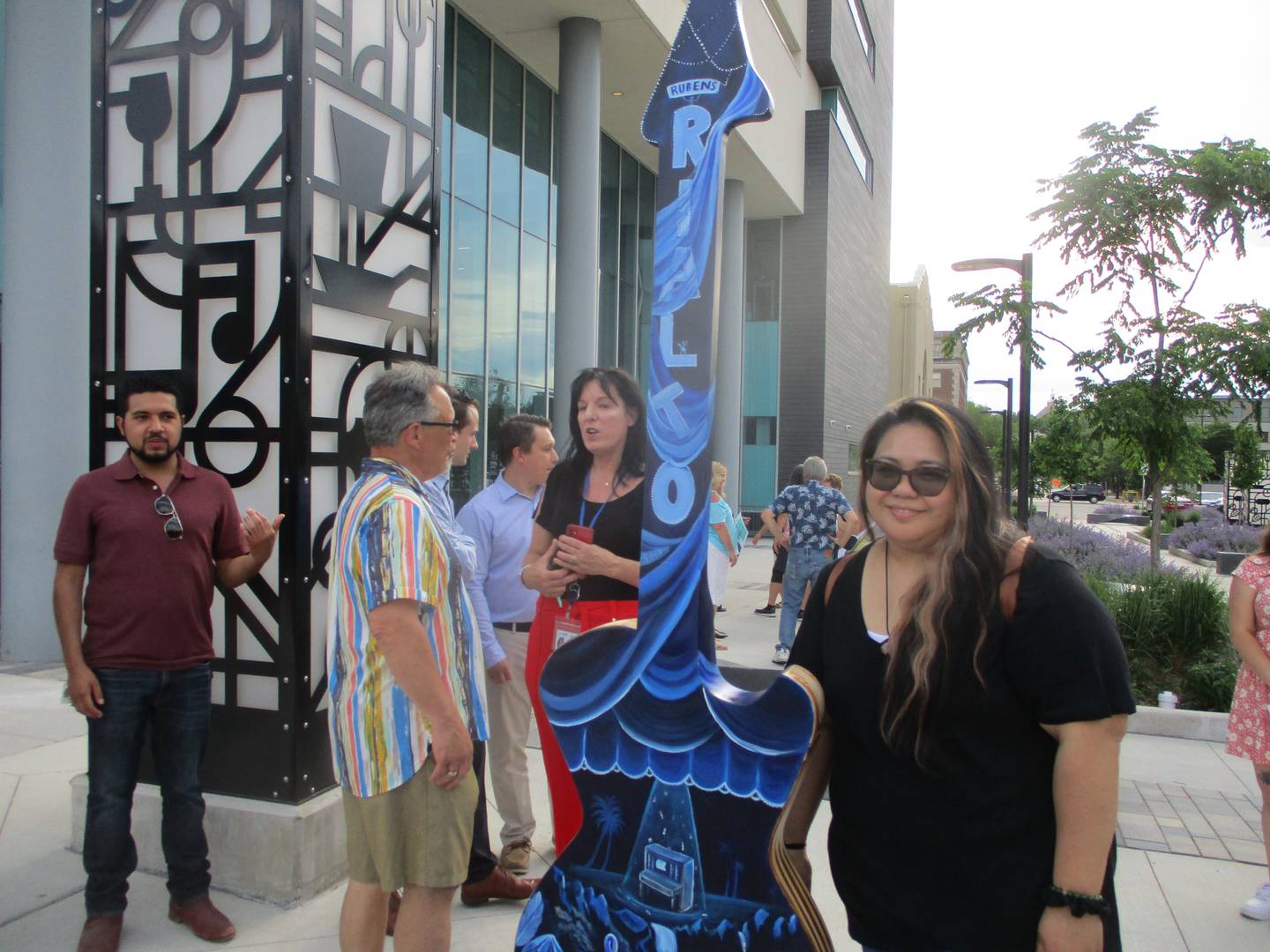 Sarah Comoda of Romeoville on Thursday stands with the guitar, "Rockin' the Paradise," that she painted for the Joliet "Ready to Rock" street art project. June 1, 2023.