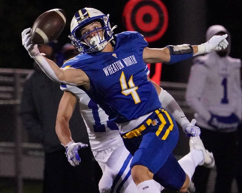 Wheaton North's Rich Schilling (4) reaches for a pass against Geneva during a football game at Wheaton North High School on Friday, Oct. 6, 2023.