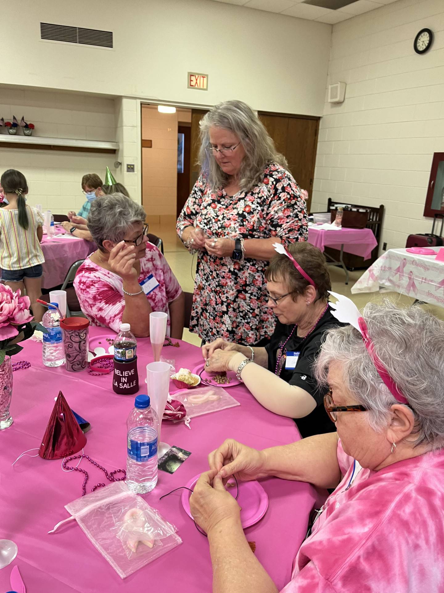 Pink Ribbon Club of the Illinois Valley meeting holds "Make and Take Your Own Mala Bracelet" under the instruction of Christy Donahue. Pictured seated from left are board members Liz Piacenti, Pat Pawlak and Kay Brauhn.