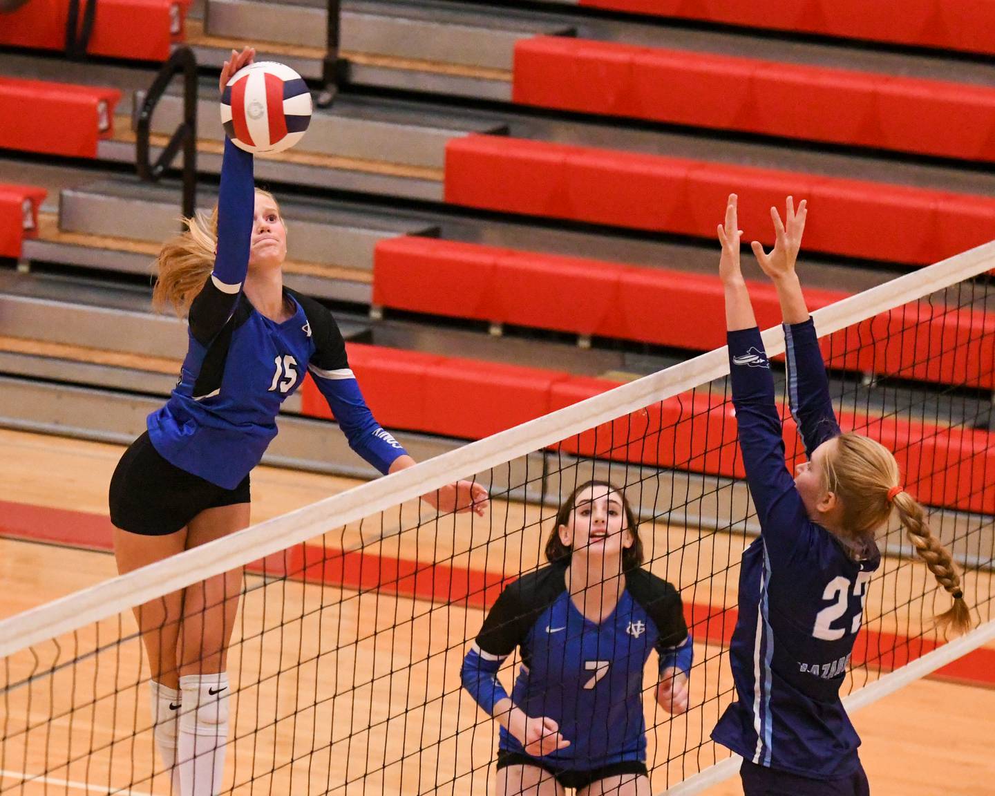 Geneva's Emma Peterson (15) spikes the ball past Nazareth Academy's Elizabeth Mackenzie (23) during the sectional title game on Thursday Nov. 6, 2025, held at Timothy Christian High School.