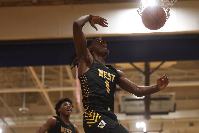 Joliet West’s Justus McNair throws down a dunk against Joliet Central.