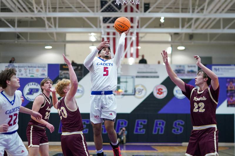 Marmion's Ali Muhammed Tharwani (5) shoots a floater in the paint against Morris’ RJ Kennedy (20) during a basketball game in the opening round of the 61st annual Plano Christmas Classic at Plano High School on Monday, December 23, 2024.
