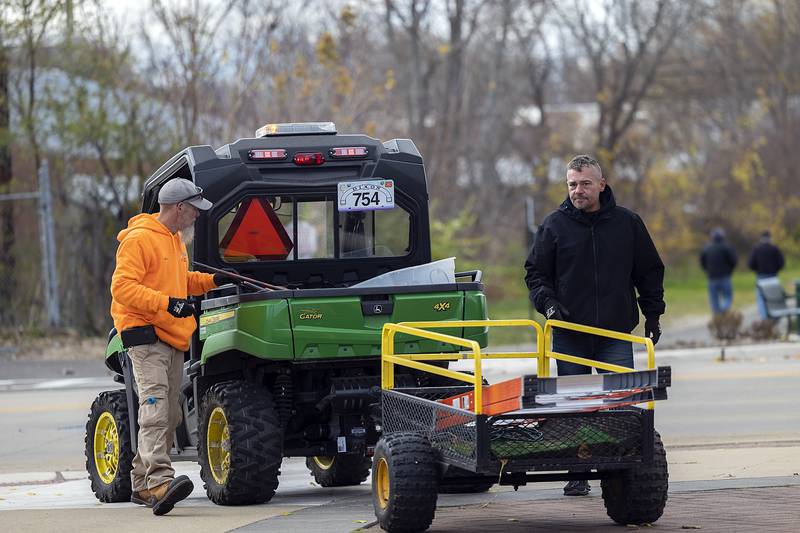Clayton Beach (left) and Jake Turner work to unload gear Wednesday, Nov. 20, 2024, as they decorate the Dixon riverfront. City workers hit the streets to trim the downtown for the holidays.