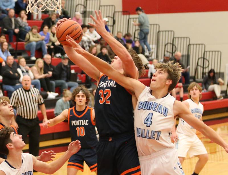 Pontiac's Logan Barrett (32) grabs a rebound over Bureau Valley's Landon Hulsing (4) during the Colmone Classic tournament on Monday, Dec. 5, 2022 at Hall High School in Spring Valley.