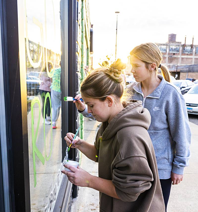 Rock Falls volleyball players Sophia Moeller (left) and Kacie Witherow decorate a downtown storefront Monday, Nov. 6, 2023 in anticipation of the team’s trip to state this weekend. The team will leave for Normal Thursday morning and face off against Breese in a semifinal game Friday at 1:30 pm.