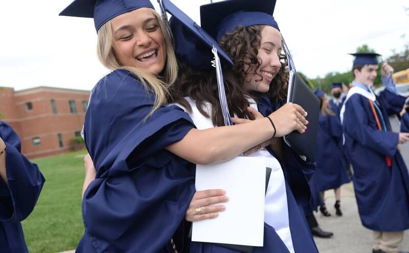 Nazareth class of 2022 graduates (left-right) Sarah Battaglia of Hinsdale, Antonia Albanese of Chicago and Lillian Murphy of La Grange embrace in a hug after their graduation ceremony Sunday May 22, 2022.