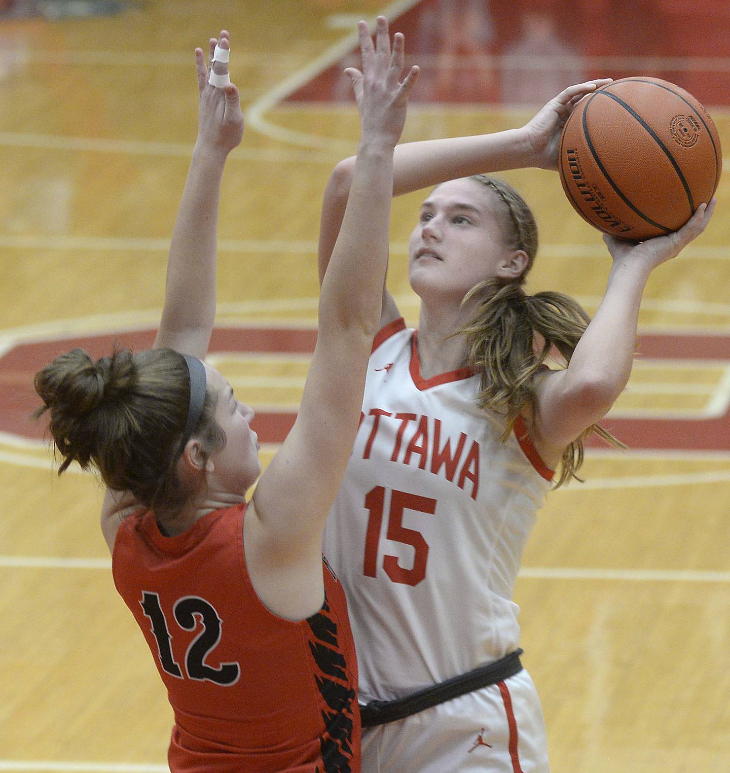 Ottawa's Hailey Larsen (15) shoots while being defended by Metamora's Shealyn Terry (12) on Monday, Jan. 2, 2023, at Ottawa's Kingman Gym.