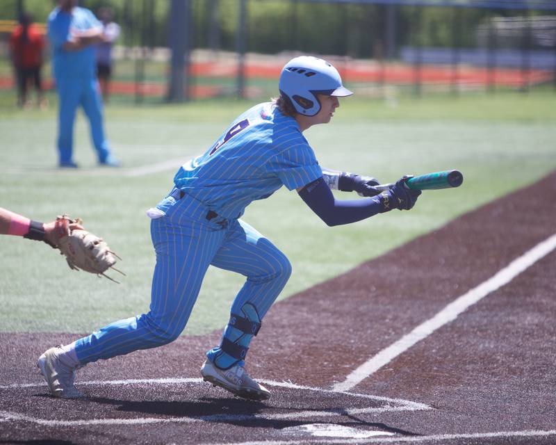 Marquette's Jaxsen Higgins lays down a bunt again Harvest Christian  at the Class 1A Sectional Final on Saturday May 25, 2024 in Elgin.
