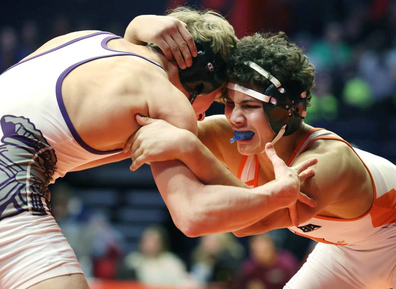 DeKalb’s Jacob Luce and Downers Grove North’s Harrison Konder lock up during the Class 3A 145 pound 5th place match in the IHSA individual state wrestling finals in the State Farm Center at the University of Illinois in Champaign.