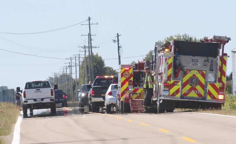 Firefighters, La Salle County Sheriff and other authorities gather along North 33rd Road next to a bean field near Wallace Grade School on Wednesday, Aug. 30, 2023 north of Ottawa. Wallace Fire Department, Illinois State Police and Ottawa Police Department were called to the school shortly after a student who ran ran out of the school and into a cornfield.