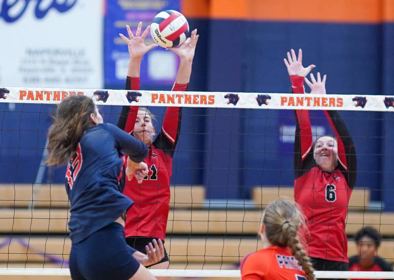 Yorkville's Clare Knoll (11) and Yorkville's Hannah Adam (6) defend the net against a kill attempt by Oswego’s Sidney Hamaker (13) during a volleyball match at Oswego High School on Thursday, Sept. 14, 2023.