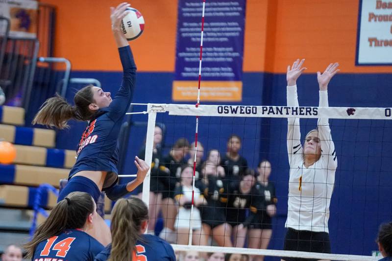 Oswego’s Sidney Hamaker (13) goes up for a kill attempt against Joliet West's Emma Salerno (1) during a volleyball match at Oswego High School on Thursday, October 24, 2024.