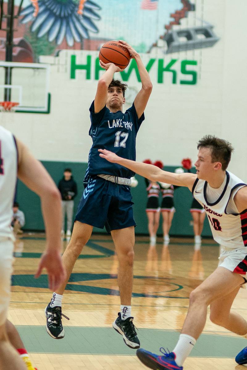 Lake Park's Joshua Gerber (12) shoots the ball on the top of the key against Benet’s Andy Nash (10) during a Bartlett 4A Sectional semifinal boys basketball game at Bartlett High School on Tuesday, Feb 28, 2023.