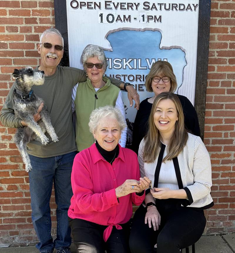 The new director for Tiskilwa Historical Society, Leah Metcalf (front right) was recently welcomed and handed over the keys to the kingdom by current director Cecille Gerber. Board members on-hand included (from left) Bill and Margaret Wendle, Julie Sampson and the official mascot, Winston.