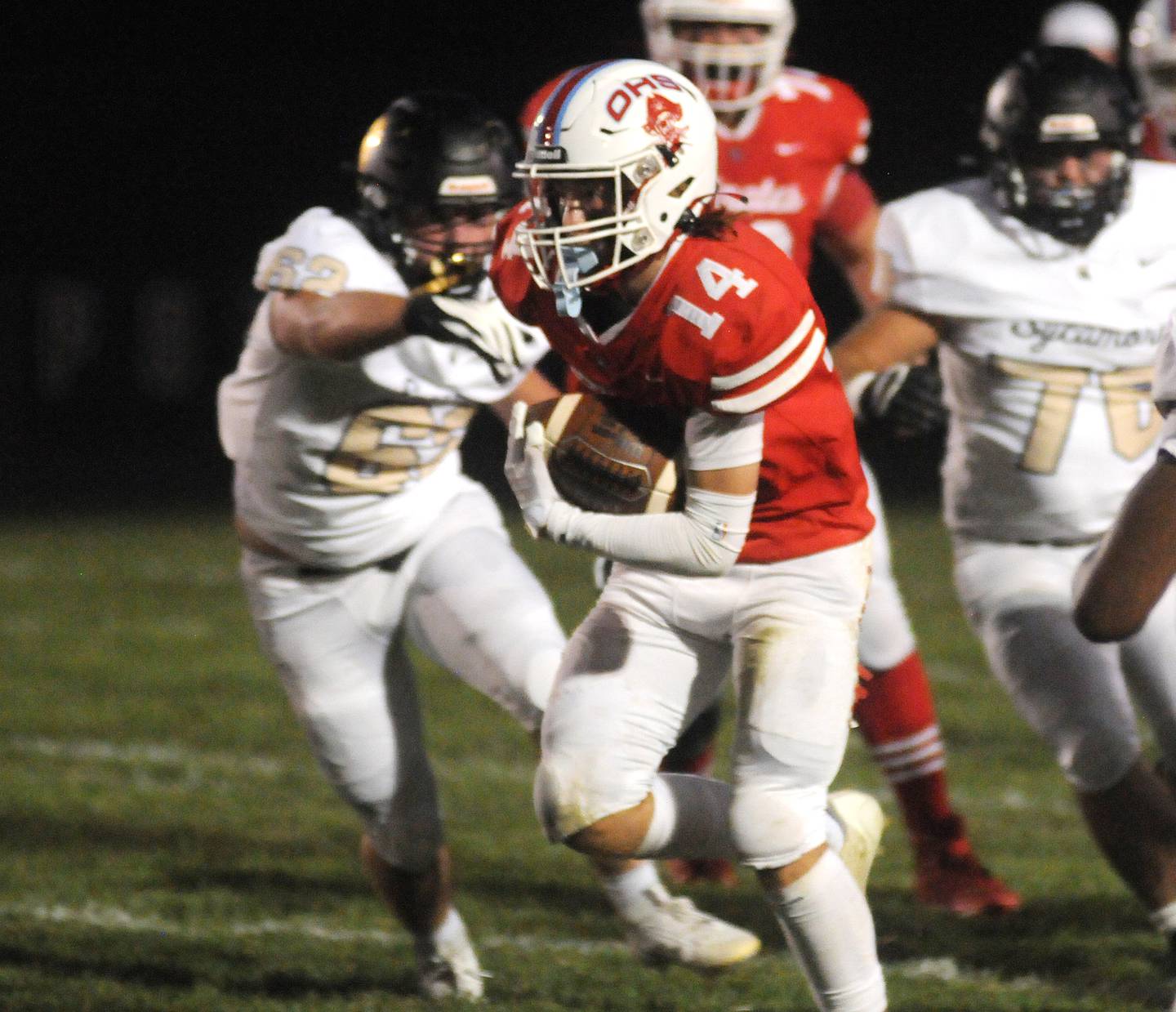 Sycamore's Ethan Keicher (62) reaches for Ottawa's Archer Cechowicz (14) at King Field on Friday, Sept. 15, 2023.