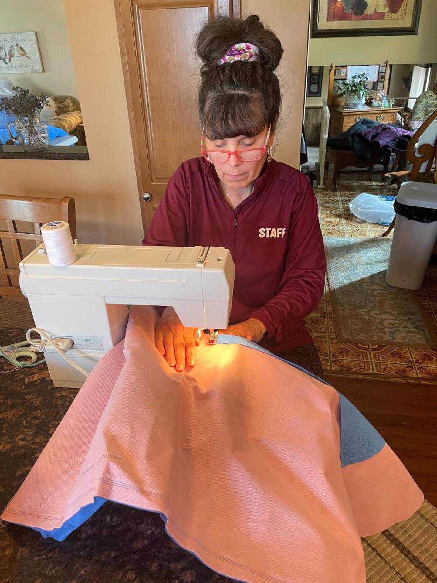 On Saturday, April 9, 2022, a small group of friends gathered at Kimberly Creasey's home in Joliet to create waterproof sleeping bags out of expired surgical drapes. The sleeping bags were sent to Poland, where they will be distributed to people from Ukraine in need. Pictured Kimberly Creasey of Joliet as she attaches drape fabric to form a sleeping bag.