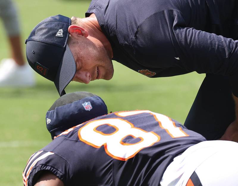 Chicago Bears head coach Ben Johnson talks to wide receiver Luther Burden III as he stretches Sunday, Aug. 10, 2025, before their preseason game against the Miami Dolphins at Soldier Field in Chicago.