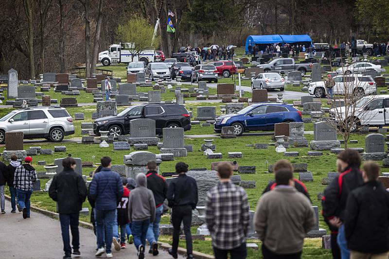 Mourners file to the gravesite of Jayden Hanson Thursday, April 4, 2024 at Riverside Cemetery in Prophetstown.