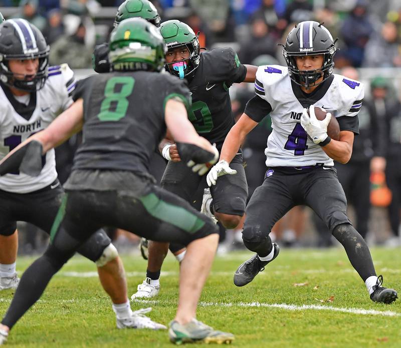Downers Grove North’s Caden Chiarelli (4) puts a move on Glenbard West defenders during a Class 7A second-round playoff game on November 8, 2025 at Glenbard West High School in Glen Ellyn.