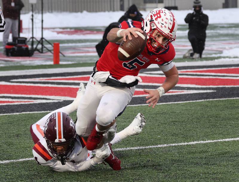 St. Rita's Steven Armbruster is sacked by Brother Rice's Javeyon Lockett Wednesday, Dec. 3, 2025, during their IHSA Class 7A state chamionship game in Huskie Stadium at Northern Illinois University in DeKalb.