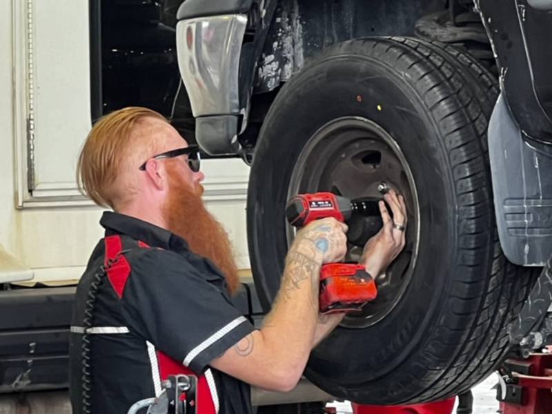 Chase Bethel of Rock Falls loosens the lug nuts on a truck Monday, July 29, 2024, at Moore Tires.