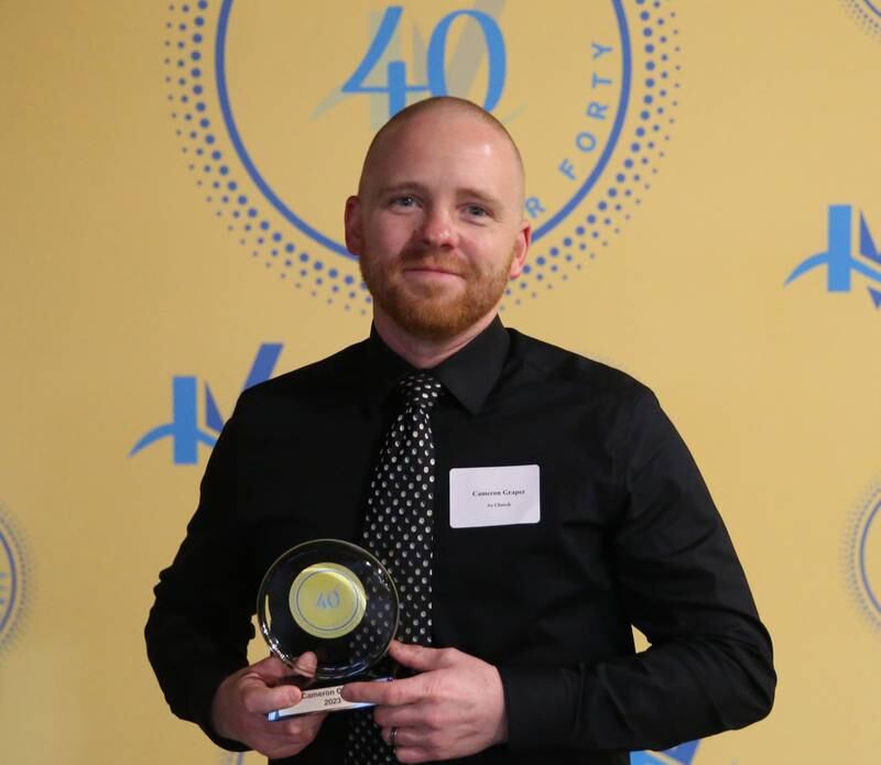 Cameron Graper poses for a photo with his award during the 40 Under Forty awards banquet on Thursday, March 21, 2024 at Westclox in Peru.