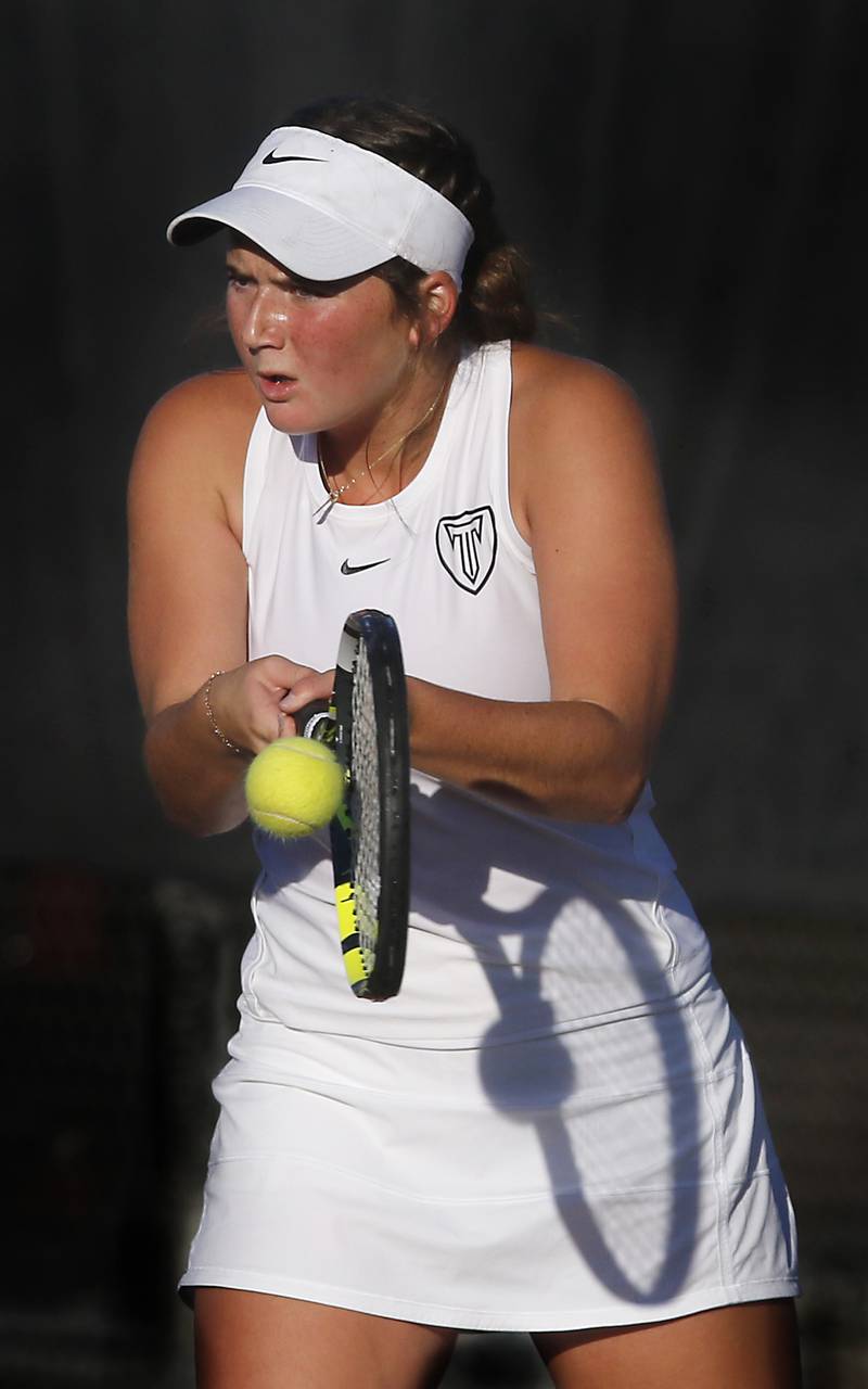 Triad’s London Looby returns the ball Thursday, Oct. 23, 2025, during the first day of the IHSA State Girls Tennis Tournament at Schaumburg High School.