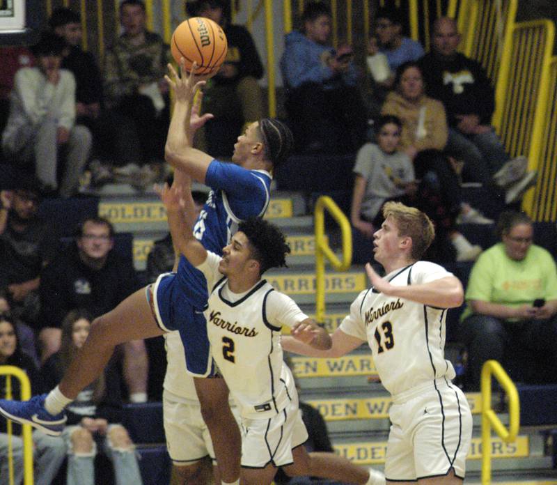 Sterling's Quiuncy Maas and Will Ports attempt to defend the basket against Quincy. The action took place on Friday, December 13th at Sterling.