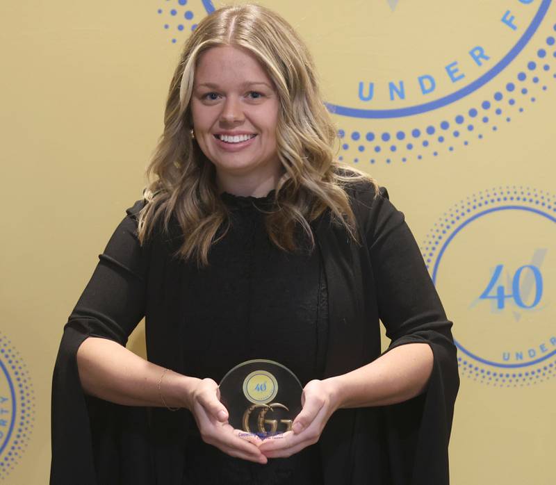 Cailey Taylor poses with her 40 Under Forty award during the Illinois Valley Chamber of Commerce Champions of Change Awards Night on Wednesday, May 6, 2026 at the Westclox Event Center in Peru.