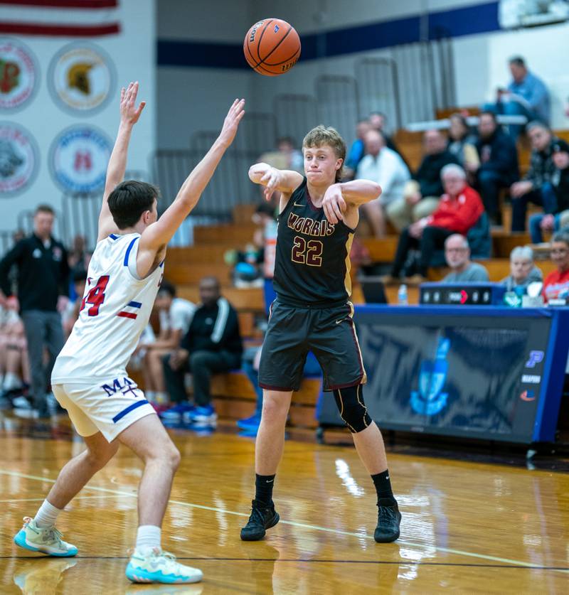 Morris’ Gage Philips (22) throws a pass in to the post against Marmion during the 59th Annual Plano Christmas Classic basketball tournament at Plano High School on Tuesday, Dec 27, 2022.