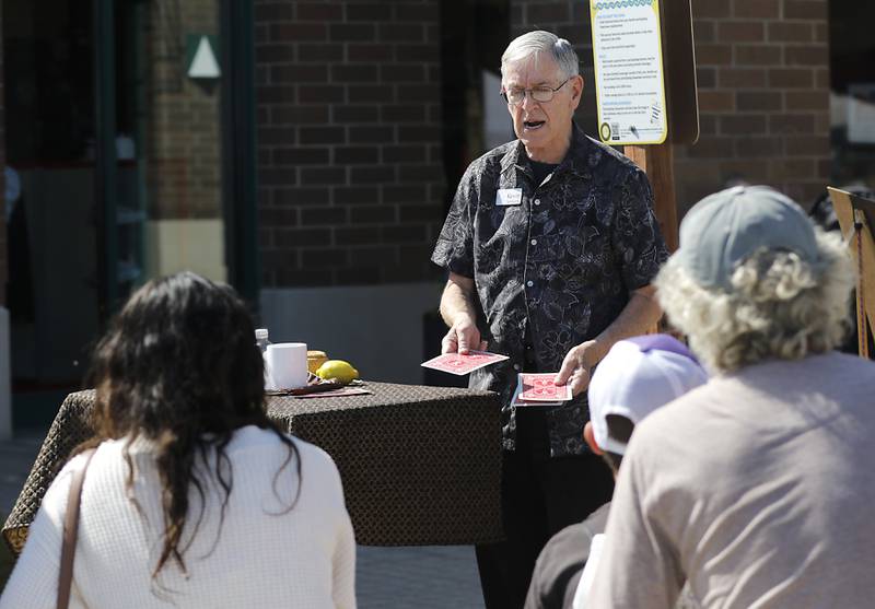 Kevin Sarnwick performs a magic trick during the Johnny Appleseed Festival on Saturday, Sept. 27, 2025, in downtown Crystal Lake. The festival featured live performances, food and family-friendly activities.