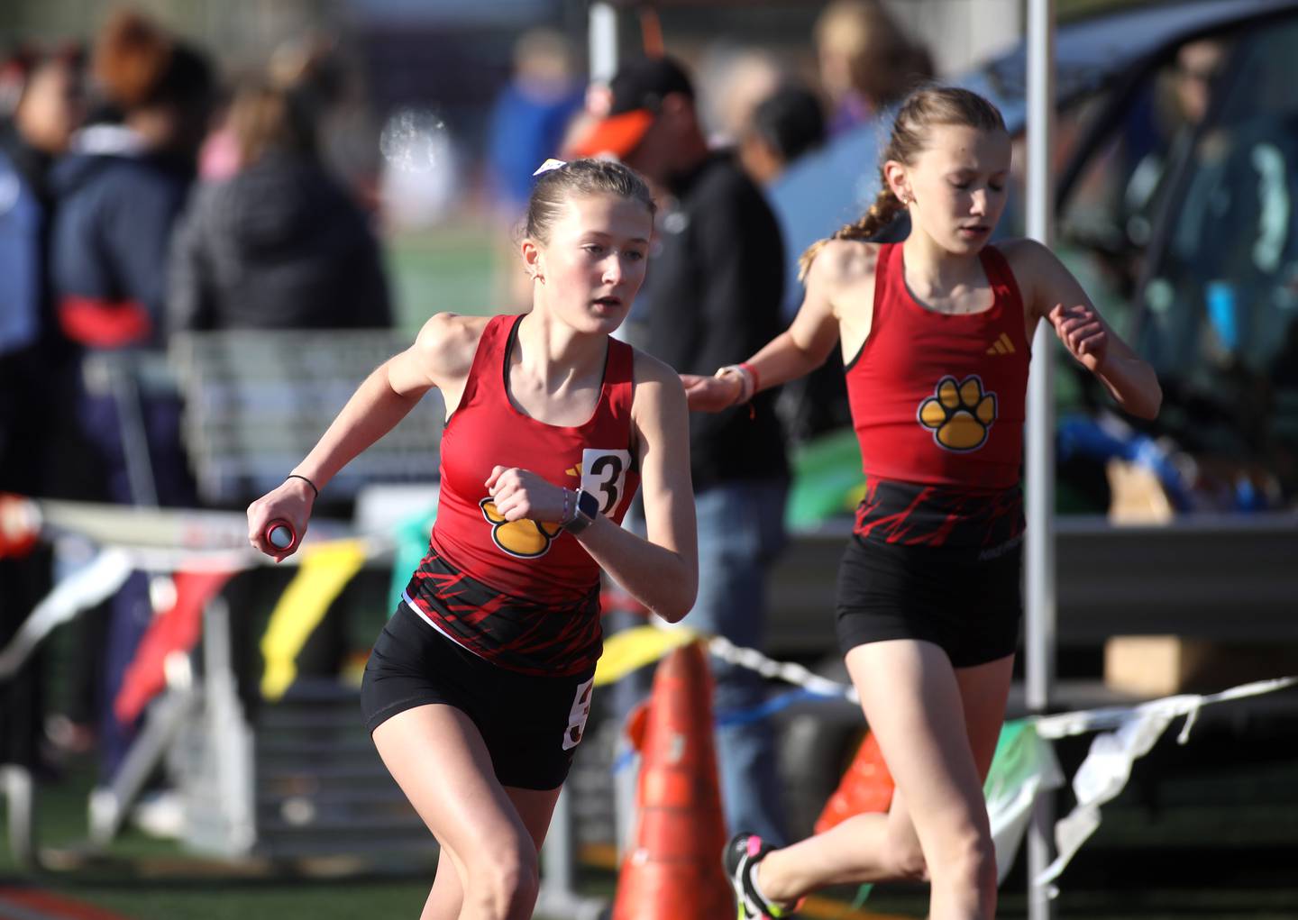 Batavia’s Avery Hacker takes the baton to run the anchor leg of the 4 x 800-meter relay during the 2024 Kane County Girls Track and Field meet at St. Charles East on Thursday, April 25, 2024.