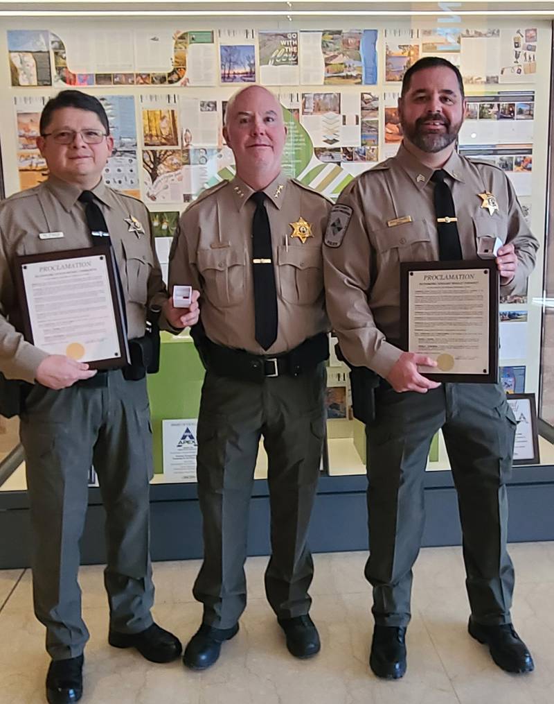 Officer Michael Viramontes (left) and Sgt. Bradley Ehrhardt (right) with Director of Public Safety Ron Davis. The officers were recognized for locating a man missing overnight in the frigid temperatures.