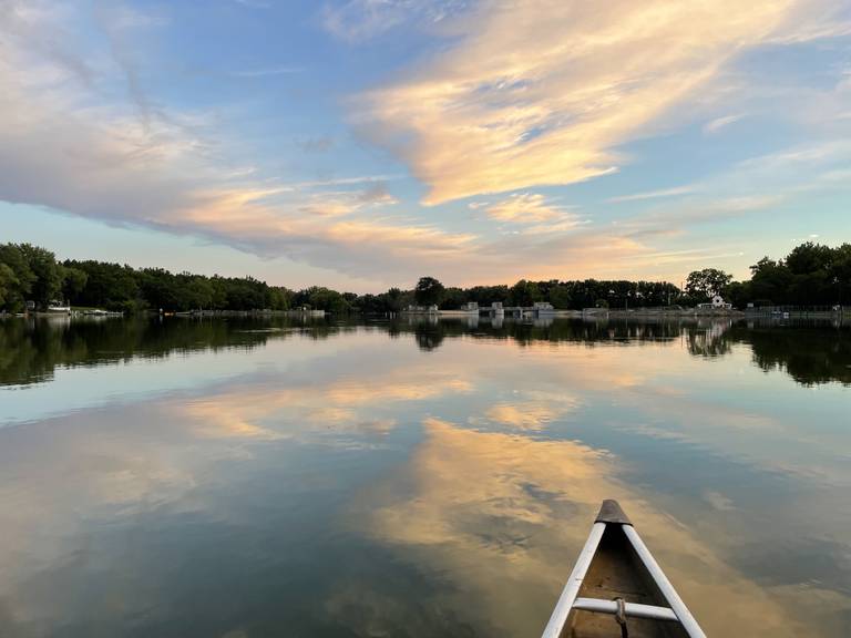 Jenni Schiavone canoes down the length of the Fox River to support the Friends of the Fox' efforts to preserve and clean up the river; here Schiavone observes a sunset on the river near McHenry on Monday, Sept. 12, 2022.