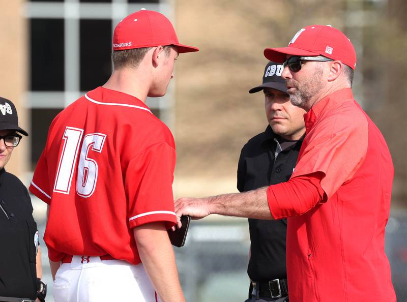 Naperville Central head coach Mike Stock goes to the mound to check on pitcher Chase Reeder after he was hit in the foot with a come backer Monday, April 28, 2025, during their game at DeKalb High School.