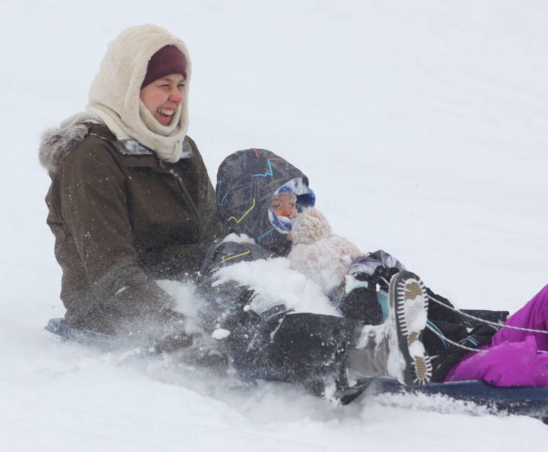 Sledders make their way down the hill at Veteran Acres on Sunday, Dec. 7, 2025 in Crystal Lake.