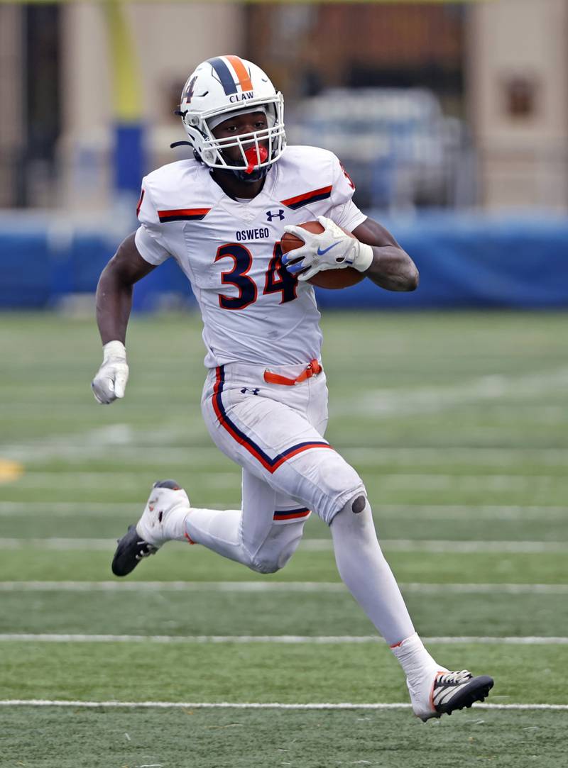 Oswego's Ammar Banire (34) runs the ball during the varsity football second-round 8A playoff game between Oswego and Lane Tech on Saturday, Nov. 8, 2025 in Chicago.