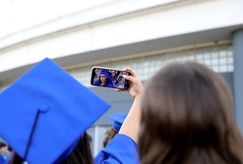 St. Charles North graduates pose for photos following the school’s 2023 commencement ceremony at Northern Illinois University in DeKalb on Monday, May 22, 2023.