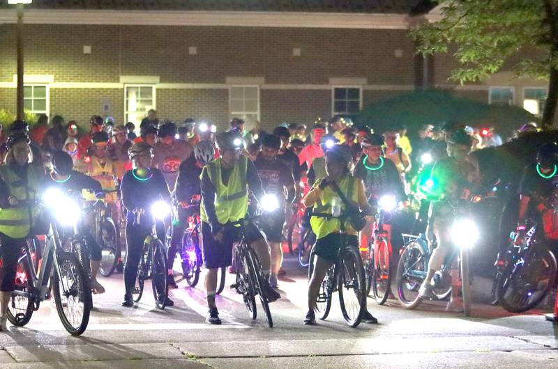 Participants begin the Raue Center for the Arts Night Owl Bike Ride in Crystal Lake on Saturday, August 2, 2025.