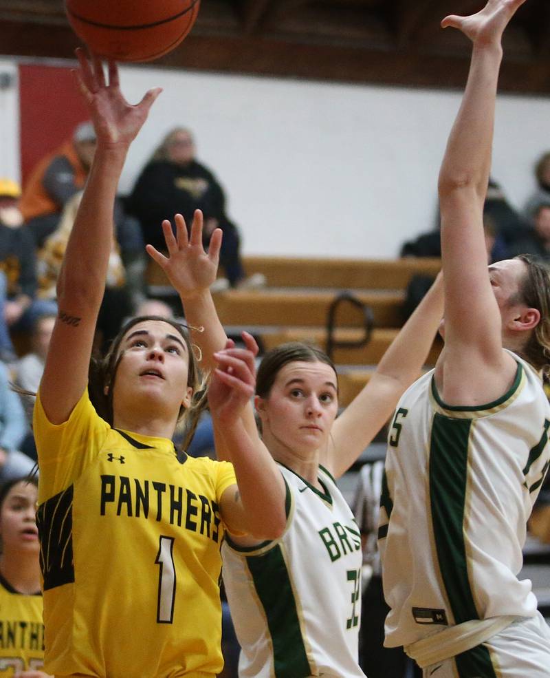 Putnam County's Ava Hatton eyes the hoop as St. Bede's Quinn McClain and Ashlyn Ehm defend during the Tri-County Conference Tournament championship game on Thursday, Jan. 18, 2024 at Henry-Senachwine High School.