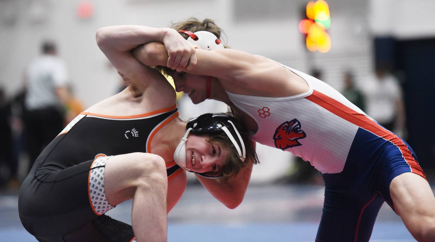 St. Charles East’s Ben Davino, left, wrestles Conant’s Sammy Santangelo in a 120-pound match during the semifinals of the Conant wrestling sectional in Hoffman Estates Saturday.
