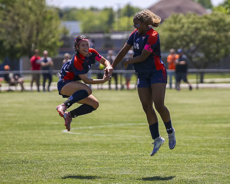 Oswego's Kailey Smith (12) and Jordyn Washington (18) celebrate their win over Neuqua Valley for the Class 3A regional final soccer match on Saturday, May 23, 2026 in Oswego