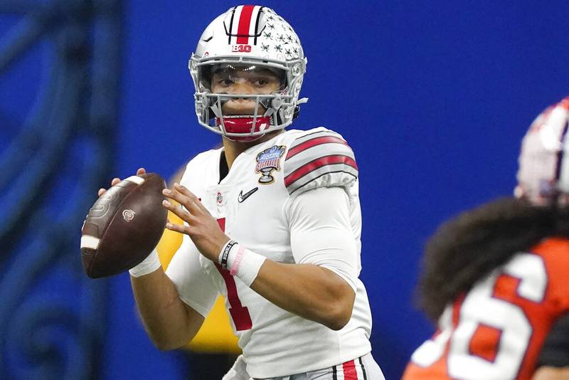 FILE - In this Friday, Jan. 1, 2021, file photo, Ohio State quarterback Justin Fields passes against Clemson during the second half of the Sugar Bowl NCAA college football game in New Orleans. Fields is foregoing his senior season to enter the NFL draft, in an announcement posted on social media, Monday, Jan. 18, 2021. Fields, expected to be a first-round draft choice, went 20-2 as a two-year starter for the Buckeyes. (AP Photo/John Bazemore, File)