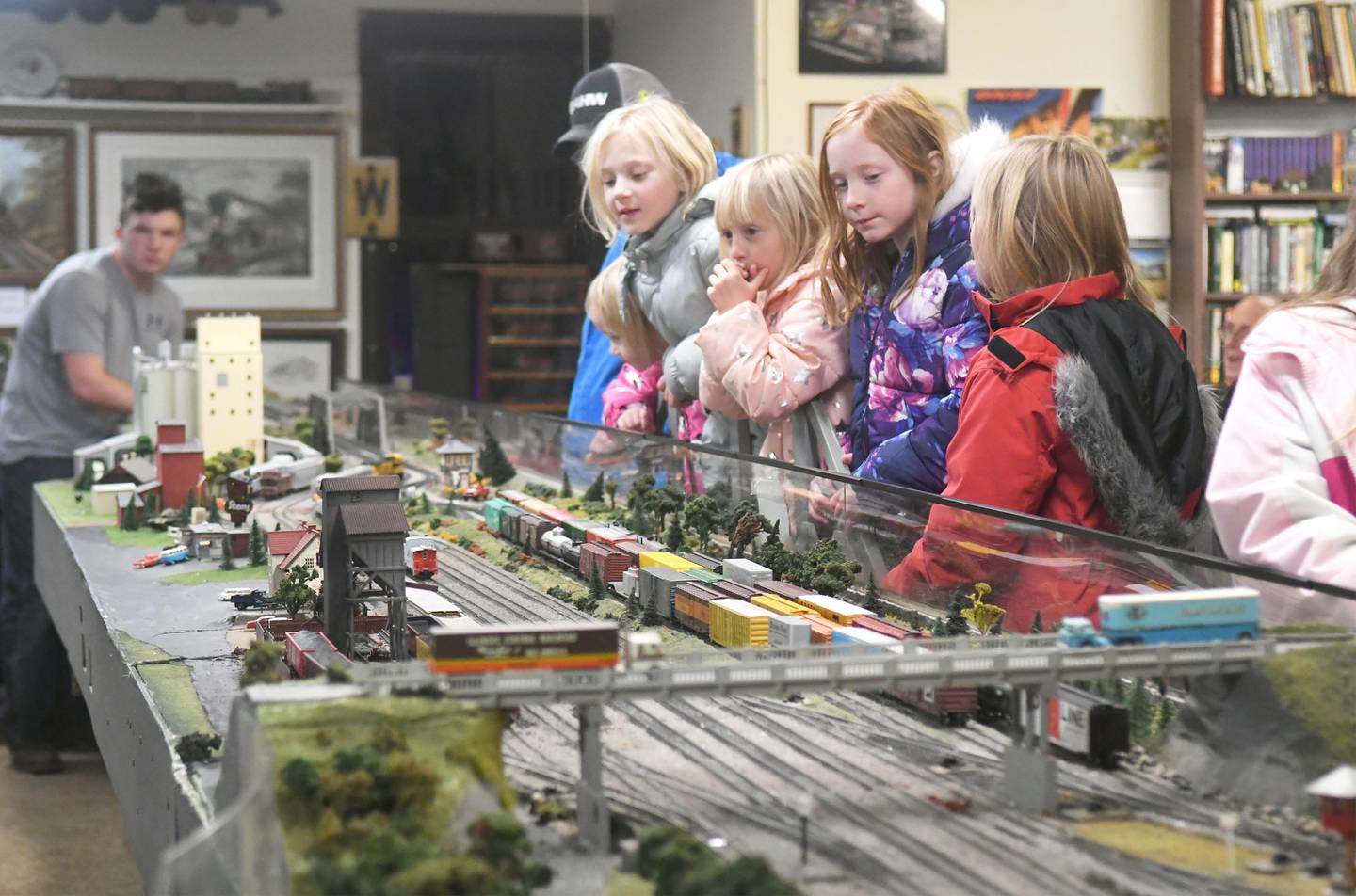 The Harbaugh family of Chana watch as a train makes it way across one of the tracks at the Blackhawk Model Railroad Club in Conover Square during Oregon's Candlelight Walk on Nov. 26. Brooklyn, Ashley, Paisley, Emily and Shelby watched the the trains with ther mom and dad, Scott and Amanda.