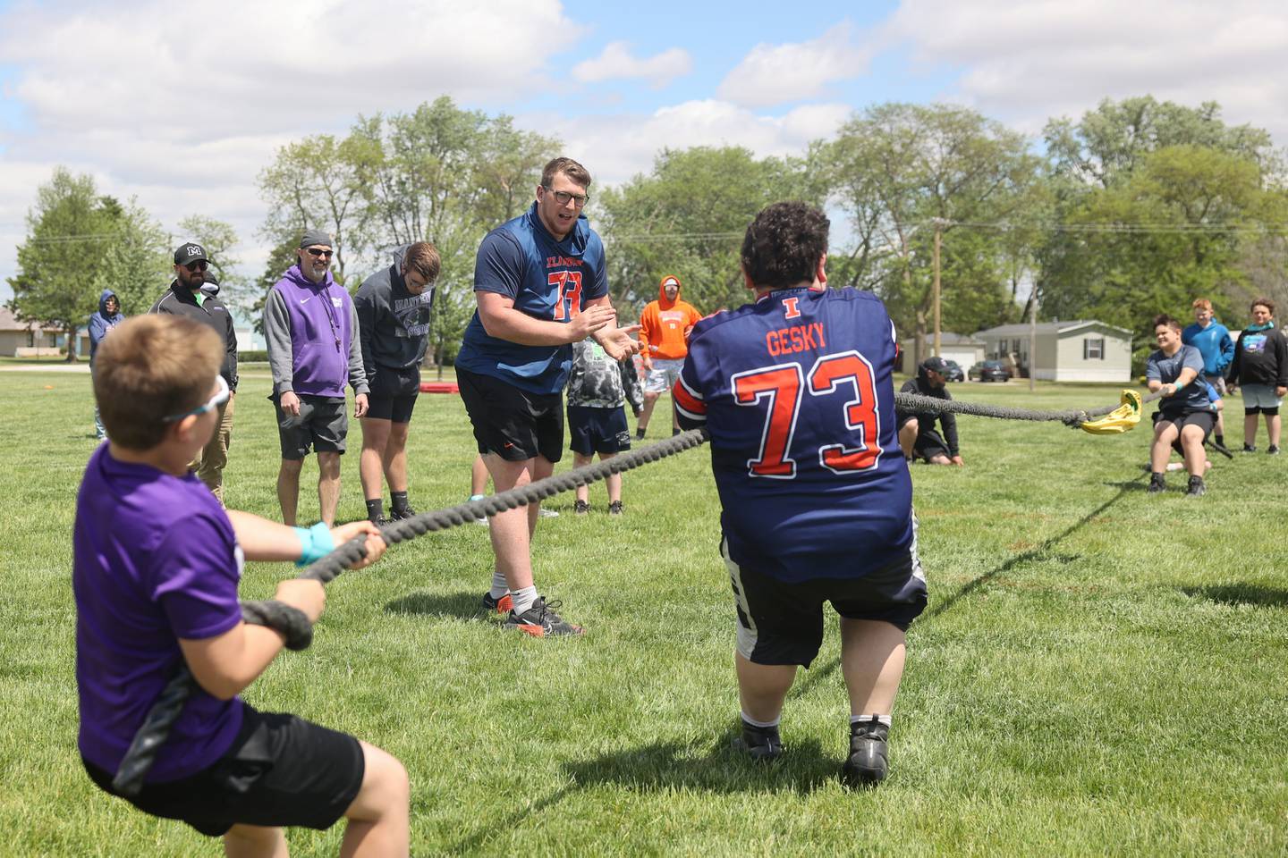 Josh Gesky, a former Manteno High School star and current offensive lineman at the University of Illinois, cheers on youth participants during a tug-of-war tournament at his inaugural Youth O-Line Camp at Legacy Park in Manteno on Saturday, May 17, 2025.