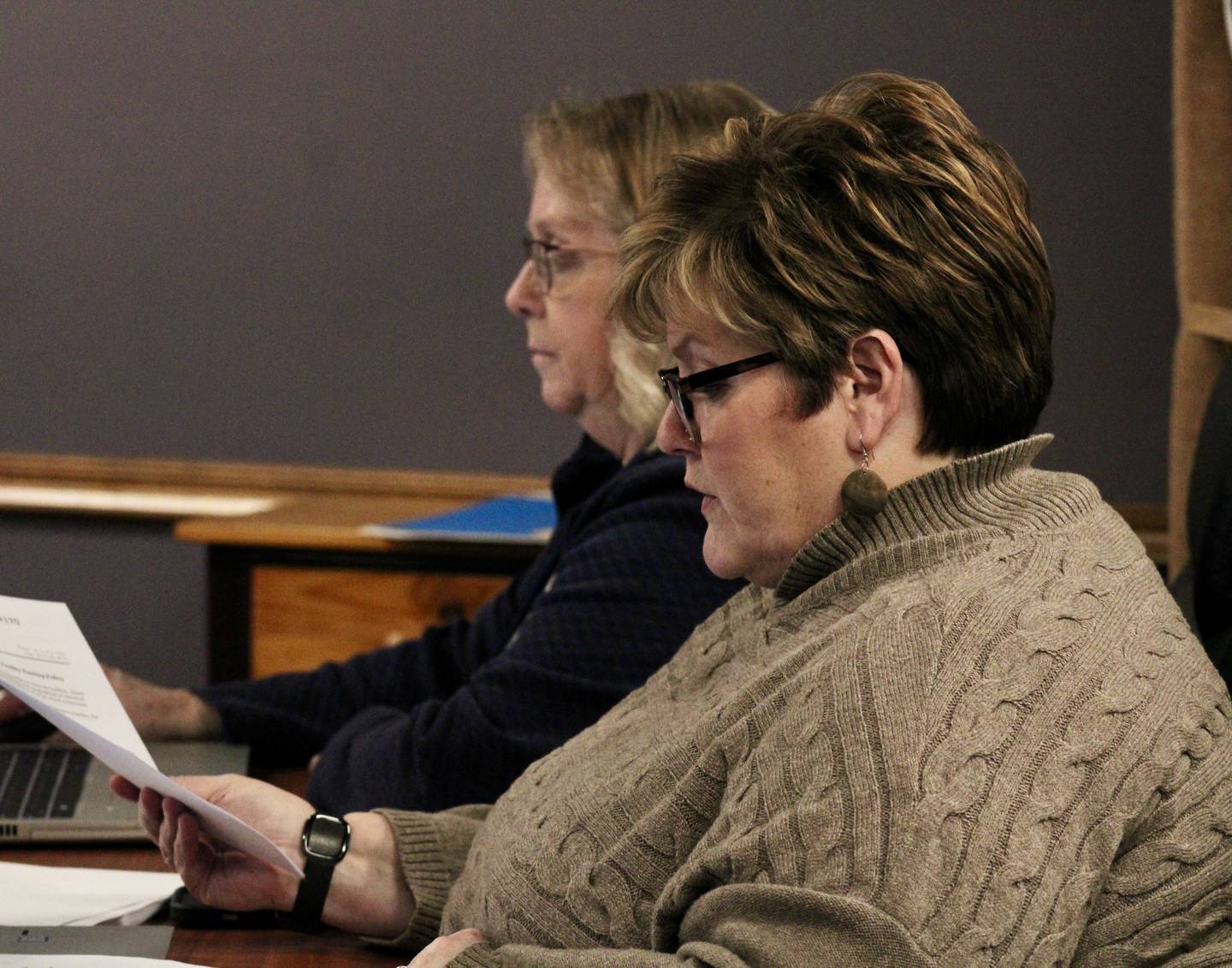 Dixon Public Schools Superintendent Margo Empen, foreground, reviews documents prior to the start of the board of education meeting on Wednesday, Feb. 15, 2023.