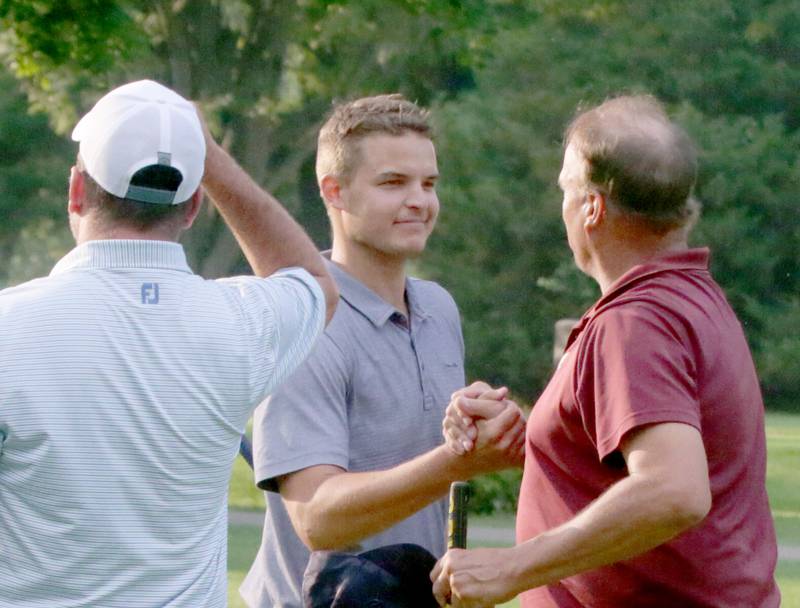 Baley Lehr (center) is congratulated by his father, Brian Lehr, after winning the Richard J. Berry Memorial Championships on Sunday, July 17, 2022, in Streator.