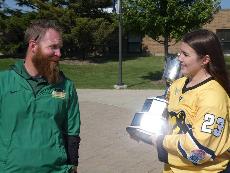 Crystal Lake South Principal Joshua Nobilio, left, meets with professional hockey player Katelynn Russ, right, who grew up in Crystal Lake. Russ proudly displayed the Isobel Cup at Crystal Lake South High School Wednesday afternoon, Aug. 24, 2022, after being part of the championship-winning Boston Pride squad this past season.